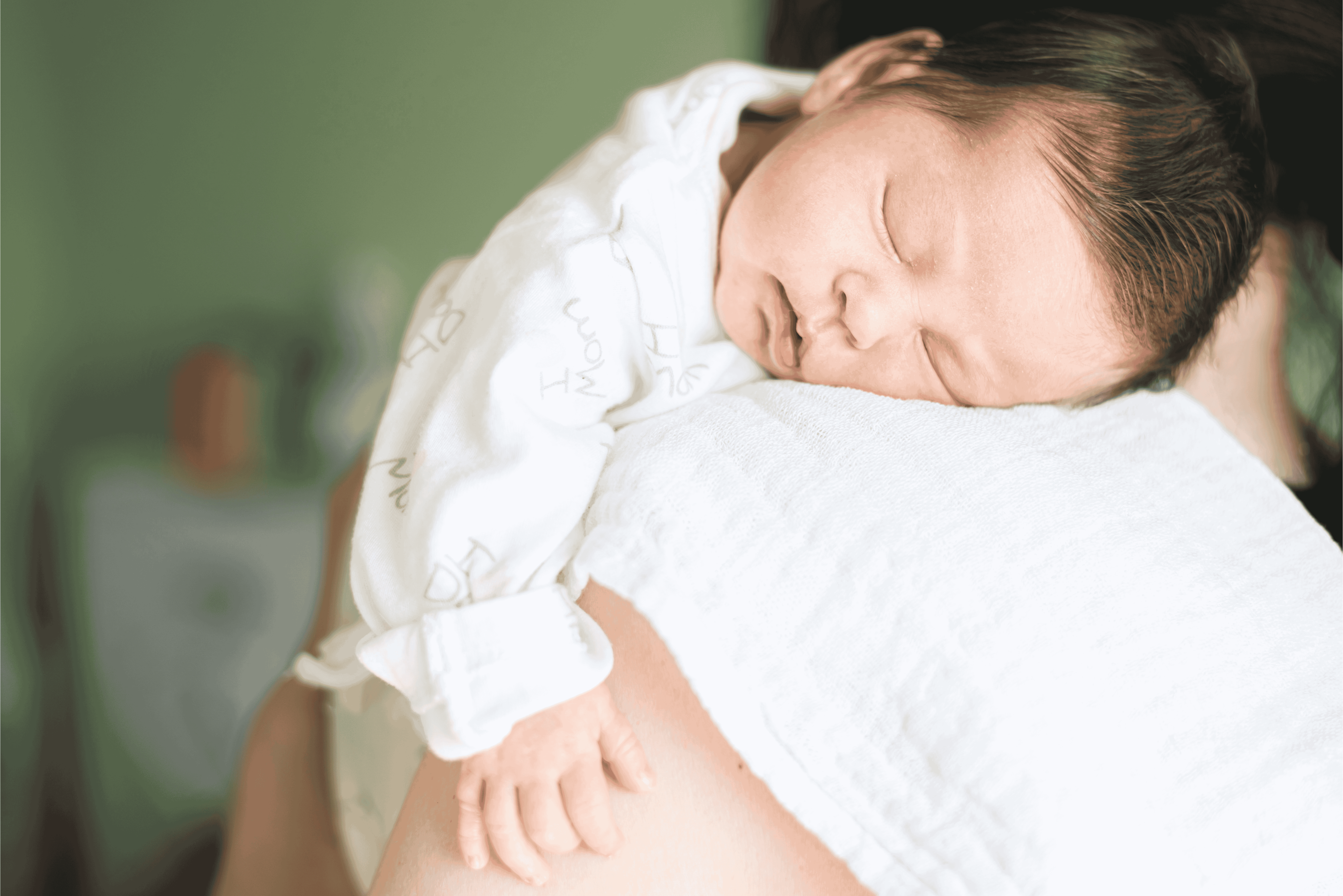 A parent soothing a baby who is showing signs of tiredness